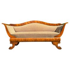 an old fashioned wooden couch with beige upholstered fabric and wood trimmings