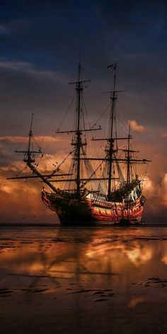 a large boat floating on top of a body of water under a sky filled with clouds