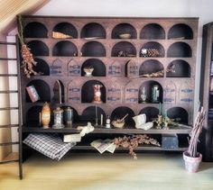 an old wooden shelf filled with lots of bottles and knick - knacks