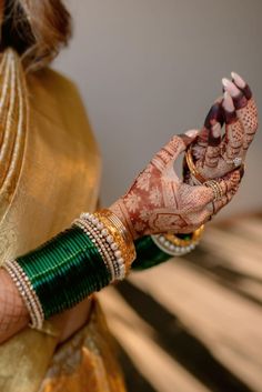 a close up of a woman's hands with hennap and bracelets