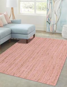 a living room with a blue couch and pink rug