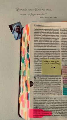 an open bible with sticky notes attached to the pages and some colored stickers on it