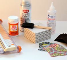 the supplies needed to make an art project are laid out on a white table top