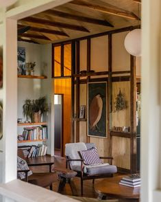 a living room filled with furniture and books