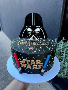 a darth vader cake with some crayons on it