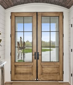 two double doors with glass and wood trim