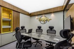 an office with marble table and black chairs