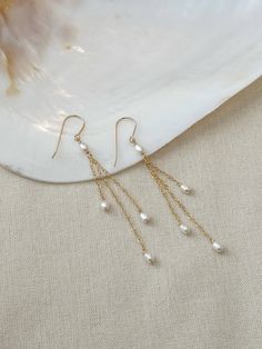 These delicate genuine pearl earrings add an elegant hint of shimmer to your special occasion look! The dainty and minimalist style is made with all sensitive skin safe materials.  * 14K Gold Filled or 925 Sterling Silver ear wire and accents * 3.5 inch length * Genuine Freshwater Pearls * Made with all hypoallergenic materials 🤍 *Please note for the health and safety of my customers, and to uphold the highest quality standards - these earrings are final sale - please dm me with any questions prior to purchase 😊 ✨  Shop all Pearl earrings here!: https://etsy.me/3Xiy4c5 GET TO KNOW MAGBEE JEWELRY! ✨  🤍 All MagBee pieces are safe for sensitive skin and made with hypoallergenic Gold Filled or 925 Sterling Silver. 🤍 I only use real/natural gemstones and Pearls. 🤍 Most items are made to or Pearl Bridal Jewelry, Bridal Earrings Pearl, Gold Pearl Earrings, Pearl Earrings Dangle, Pearl Drop Earrings, Tassel Earrings, Wedding Earrings, Bridal Earrings, Bridal Jewelry