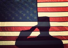 the silhouette of a soldier saluting in front of an american flag with thank you written on it