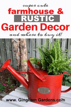 a red watering can with plants in it