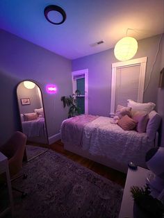 a bed room with a neatly made bed next to a window and a purple light