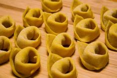 several small pieces of pasta on a wooden surface