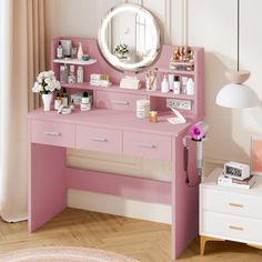 a pink desk with a mirror on top of it