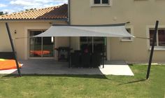 a patio covered with an awning in front of a house