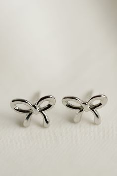 Rumor has is that 2024 is the year of BOWS! These super cute, bow stud earrings are the dainty, delicate, and prefect for all day wear. Includes two gold or silver-plated bow studs Approx. 1/2" Choose from either gold or silver Delicate Silver Jewelry With Bow, Bow Earrings Silver, Elegant Silver Bow Earrings, Gold Dainty Bow Earrings, Bow Earrings Studs, Everyday Wear Jewelry, Woman Business Owner, Cute Bow, Strong Female