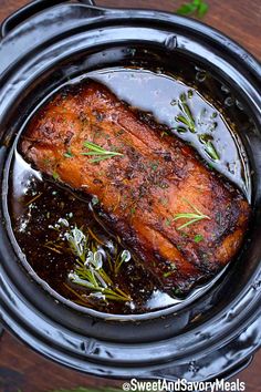 cooked salmon in a slow cooker with herbs