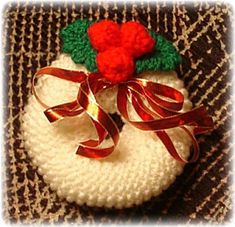 a knitted snowman ornament with a red bow