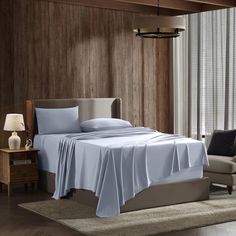 a bed in a room with wooden walls