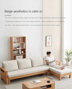 a person sitting on a couch in a living room with a coffee table and bookshelf