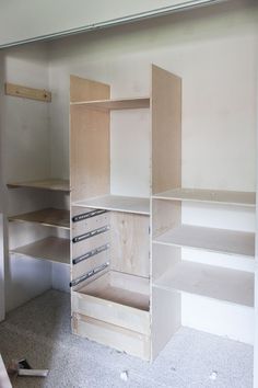 an empty room with shelves and drawers in it