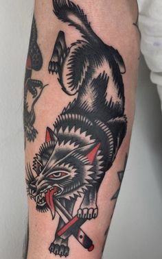 a man with a wolf tattoo on his arm