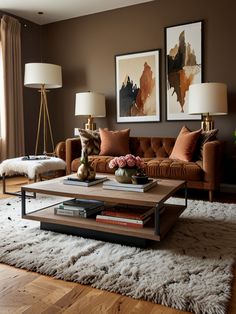 a living room with two couches, a coffee table and pictures on the wall