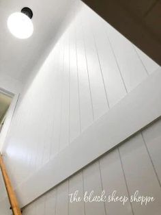 an attic with white walls and wood floors