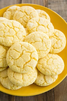 a yellow plate filled with cookies on top of a wooden table