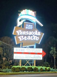 there is a large sign that says pensacoa beach