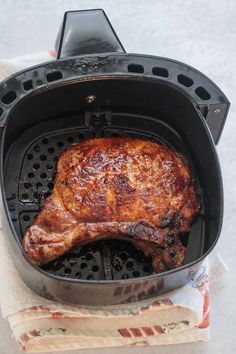 the meat is being cooked in the air fryer