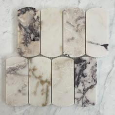 several pieces of marble sitting on top of a white counter