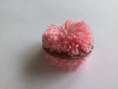 a pink slipper sitting on top of a white table