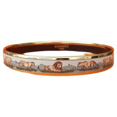 Beautiful Authentic Hermès Bracelet Print: Lions and lionesses in Savannah Theme: Africa, wild animals, jungle, savannah Made in Austria + B (1998) Vintage Bracelet Made of printed enamel and yellow gold plated hardware Colorways: beige, shades of green "HERMÈS PARIS" in golden letters inside Hallmark Size: 65 - PM Measurements: 6,5 cm Diameter (2,56 inches) / 0,95 cm Width (0,35 inch) Condition: Very Good. Enamel in excellent condition: no chips, no scratch. Micro scratches on hardware. No Hermès packaging. Will come gift wrapped This bracelet is garanteed authentic and will be shipped immediately Thank you for watching my items ! Beige Shades, Lion Bracelet, Animals Jungle, Lion And Lioness, Hermes Bracelet, Hermes Paris, Vintage Bracelet, Enamel Bracelet, Fashion Aesthetic