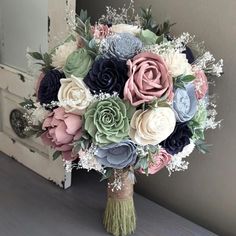 the bridal bouquet is made up of multicolored paper flowers