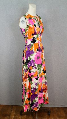 "Item Details: - 1960s floral, mid century mod maxi, by Indorables of California  - Bright floral pattern that mimics brush strokes - Defined waist - Buttons up the bodice  - Cotton blend Condition: - This dress is in great condition - There are no rips, stains, or tears * Only imperfection is a button missing at the neckline, however we have a replacement that will work perfectly  Measurements:  *estimated size S (2/4) Bust: 32in/34in Waist: 26 in Shoulder to Hem: 52 in Purveyor's Note: We have searched far and wide, wrestled bears, braved the cold, traversed mountain ranges, fought pirates, swam with sharks and eaten at many a questionable road side taco stand to provide our customers with one of a kind vintage pieces.  Know that whichever piece you choose to make your own has its own st Retro Multicolor Floral Print Maxi Dress, Multicolor Retro Maxi Dress With Floral Print, Retro Lined Maxi Dress, Retro Multicolor Maxi Dress For Garden Party, 1970s Floral Print Maxi Dress, Vintage Multicolor Maxi Dress For Garden Party, Retro Floral Print Maxi Dress, Multicolor Vintage Print Maxi Dress, Retro Pink Floral Print Maxi Dress