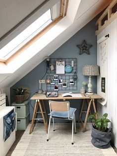 a room with a desk, chair and shelves on the wall in front of it