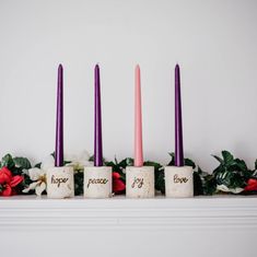 three candles with the words peace and joy written on them