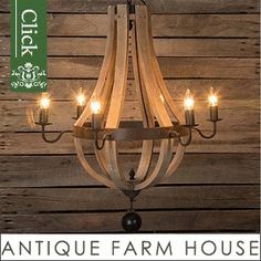 an antique farm house chandelier hanging from a wooden wall with the words click on it