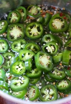 green peppers are being cooked in a pot with some seasoning on the top and bottom