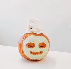 a pumpkin with a face painted on it