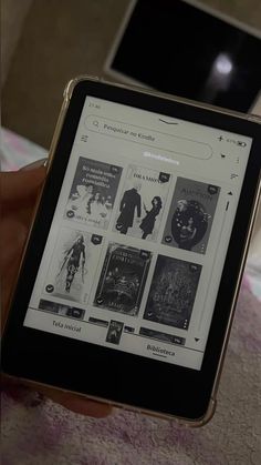 a person is holding an electronic device in their hand and looking at the book on the screen