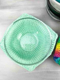 crochet dishcloths and bowl on a table with bowls in the background