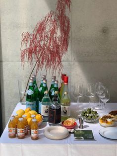 a table topped with bottles of wine and plates of food