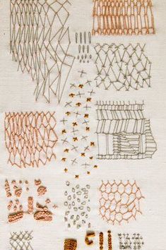 various stitches and threads are laid out on a piece of paper with orange ink