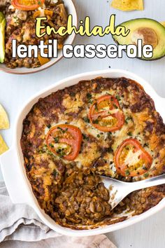 an enchilada casserole in a white dish with a serving spoon