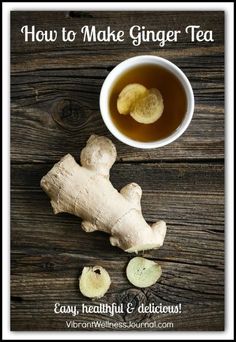 a cup of tea with ginger root next to it on top of a wooden table