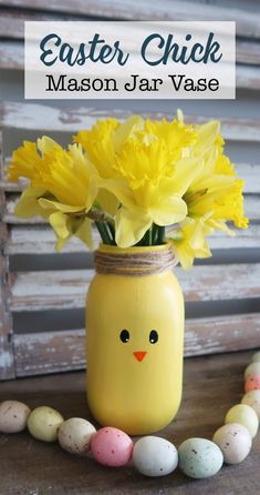 a mason jar filled with yellow flowers and eggs