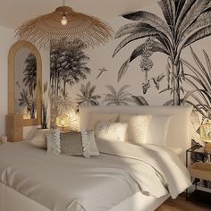 a white bed sitting under a palm tree wallpaper next to a night stand with two lamps on it