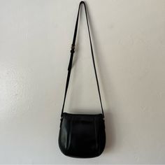 Coach Vintage Crossbody Black Bag Made In The Usa. This Is A True Quality Vintage Crossbody Purse Made Of Genuine Leather. It Has An Open Top With A Metal Closure That Secures Your Belongings. The Length Of The Strap Is Adjustable. It Has Minor Blemishes And Some Wear From Age But Is In Great Condition For Its Age. It Also Has Its Original Tag (Split But Easily Repaired). Vintage Lovers, Coach, Vintage Coach, Genuine Leather, Quality Leather, Coach Lovers, Coach Collectors Versatile Coach Bag With Detachable Strap, Versatile Coach Bag With Adjustable Strap, Chic Coach Saddle Bag With Adjustable Strap, Classic Black Saddle Shoulder Bag, Black Saddle Bag With Adjustable Strap For Formal Occasions, Classic Coach Crossbody Hobo Bag, Coach Crossbody Saddle Bag With Detachable Strap, Coach Black Crossbody Hobo Bag, Coach Crossbody Shoulder Bag For Everyday Use