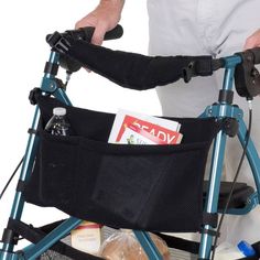 a person pushing a walker with food in it's back pocket and holding onto the handlebars